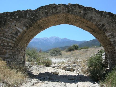 Dilapidated bridge over the Vrasi�tas; in the background Mount P�rnonas - Photo: Jaap-Jan Flinterman, summer 2011